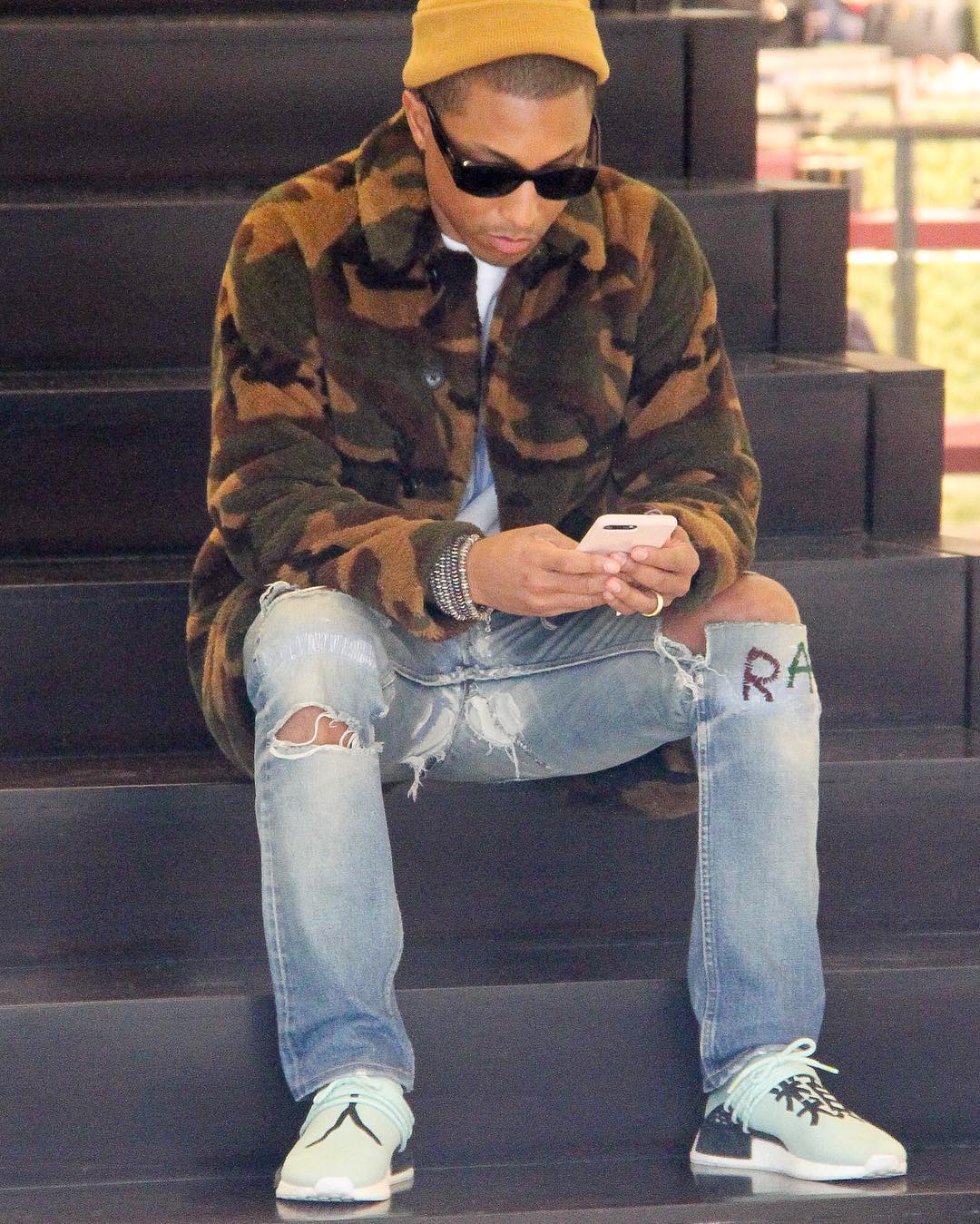 SPOTTED: Pharrell Williams In Camo Coat, Chanel Sunglasses And Adidas NMD’s