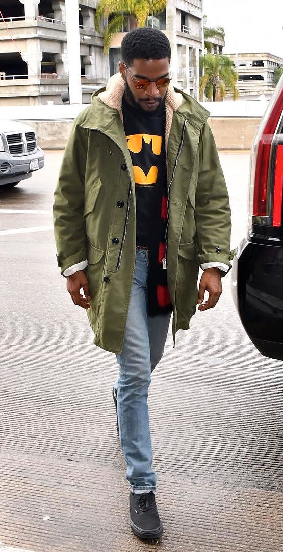 SPOTTED: Kid Kudi Wearing Saint Laurent Parka Coat, Cardigan, Vans and Ray Bans at LAX