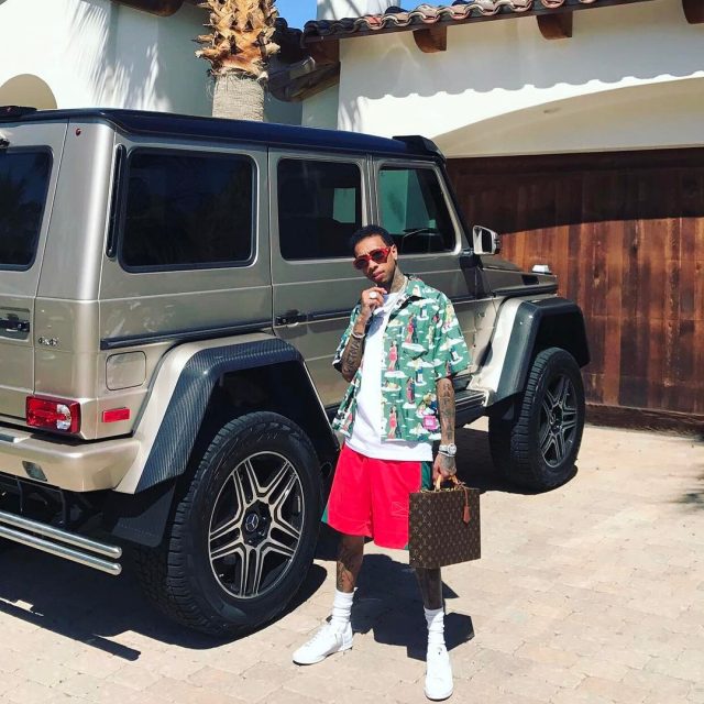 SPOTTED: Tyga In Prada Shirt, Martine Rose Shorts and Carrying Louis Vuitton Briefcase for Coachella