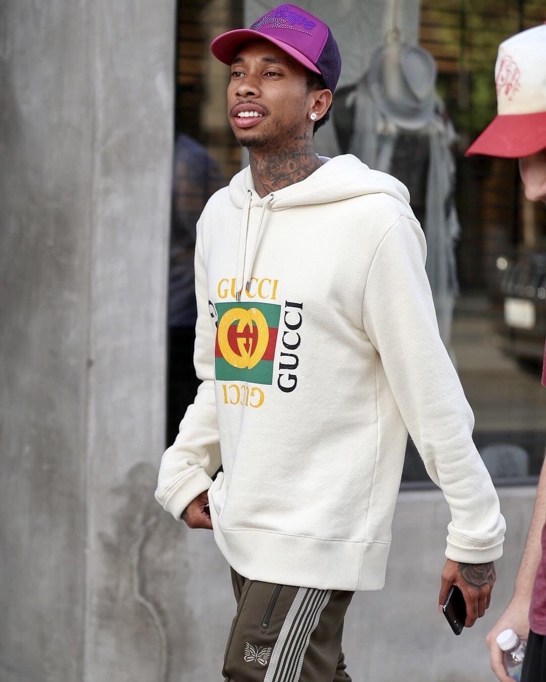 SPOTTED: Tyga in a Gucci Hoodie, Needles Track Pants and a BAPE Hat