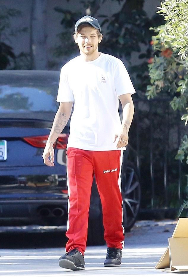 SPOTTED: Louis Tomlinson Wears Palm Angels Track Pants