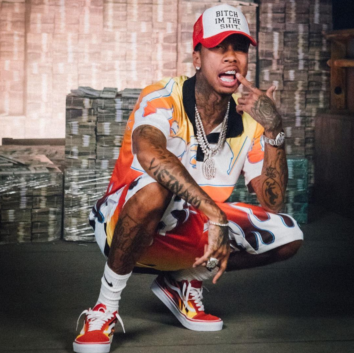 SPOTTED: Tyga In Flame Print Polo Shirt And Shorts And Custom Vans Sneakers