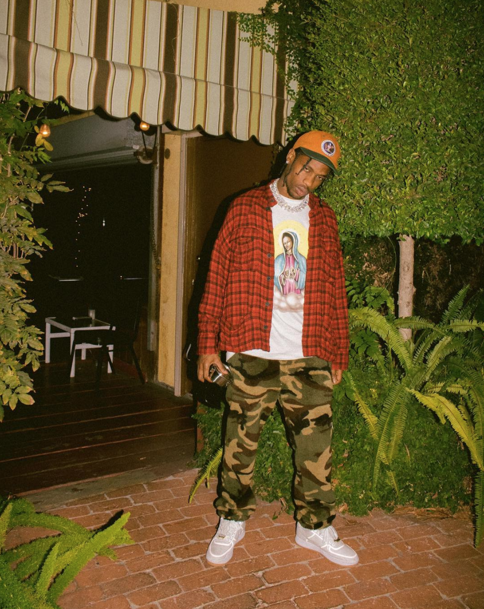 SPOTTED: Travis Scott In Supreme Pledge Allegiance 6-Panel Cap, Flannel Shirt And Nike Sneakers