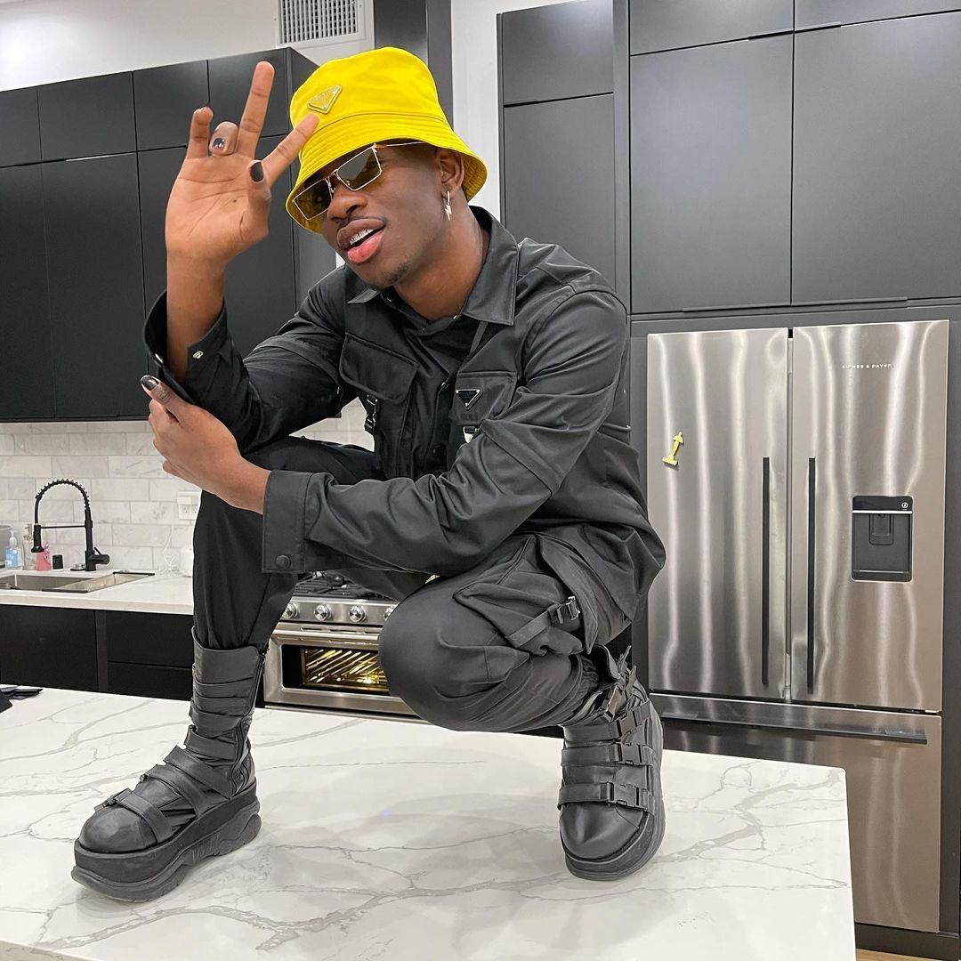 SPOTTED: Lil Nas X in Black & Yellow Prada Getup