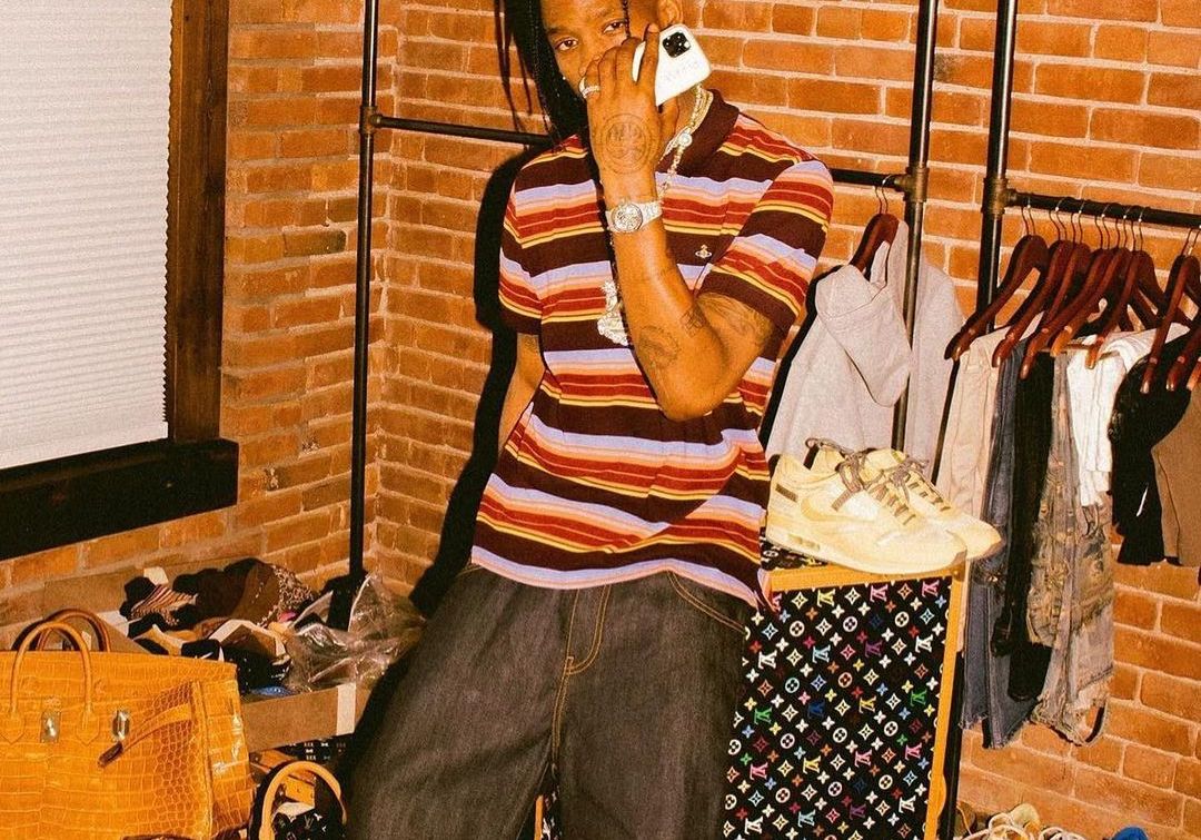 SPOTTED: Travis Scott flexes LV Luggage Collection in Vivienne Westwood