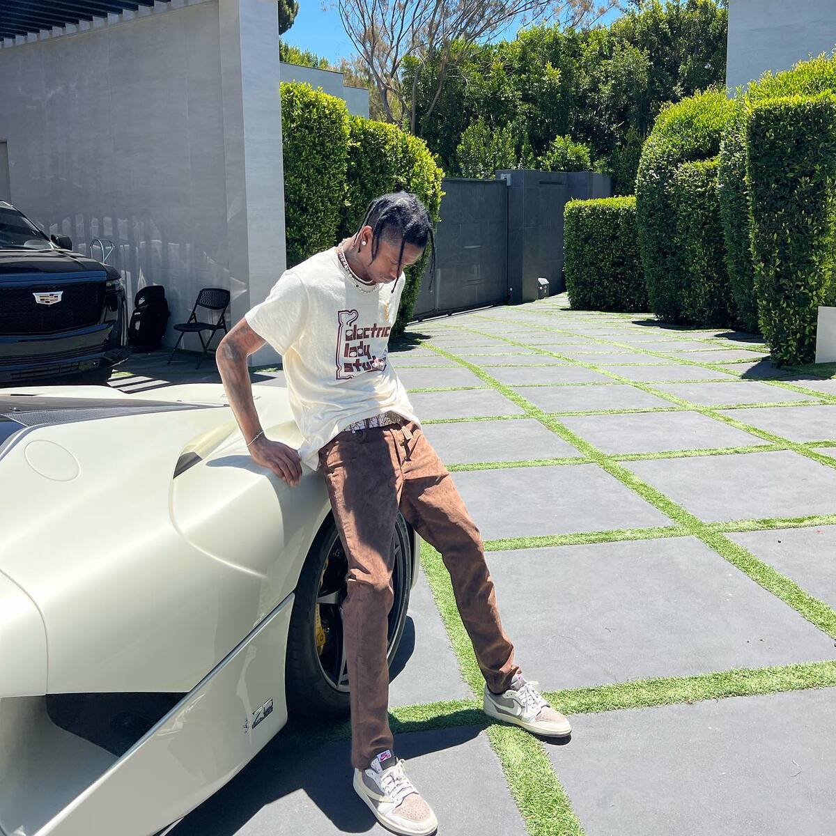 Complex Sneakers - Travis Scott with the LV Puffer and Dior Air Jordan 1s  on-foot. Highest fashion.