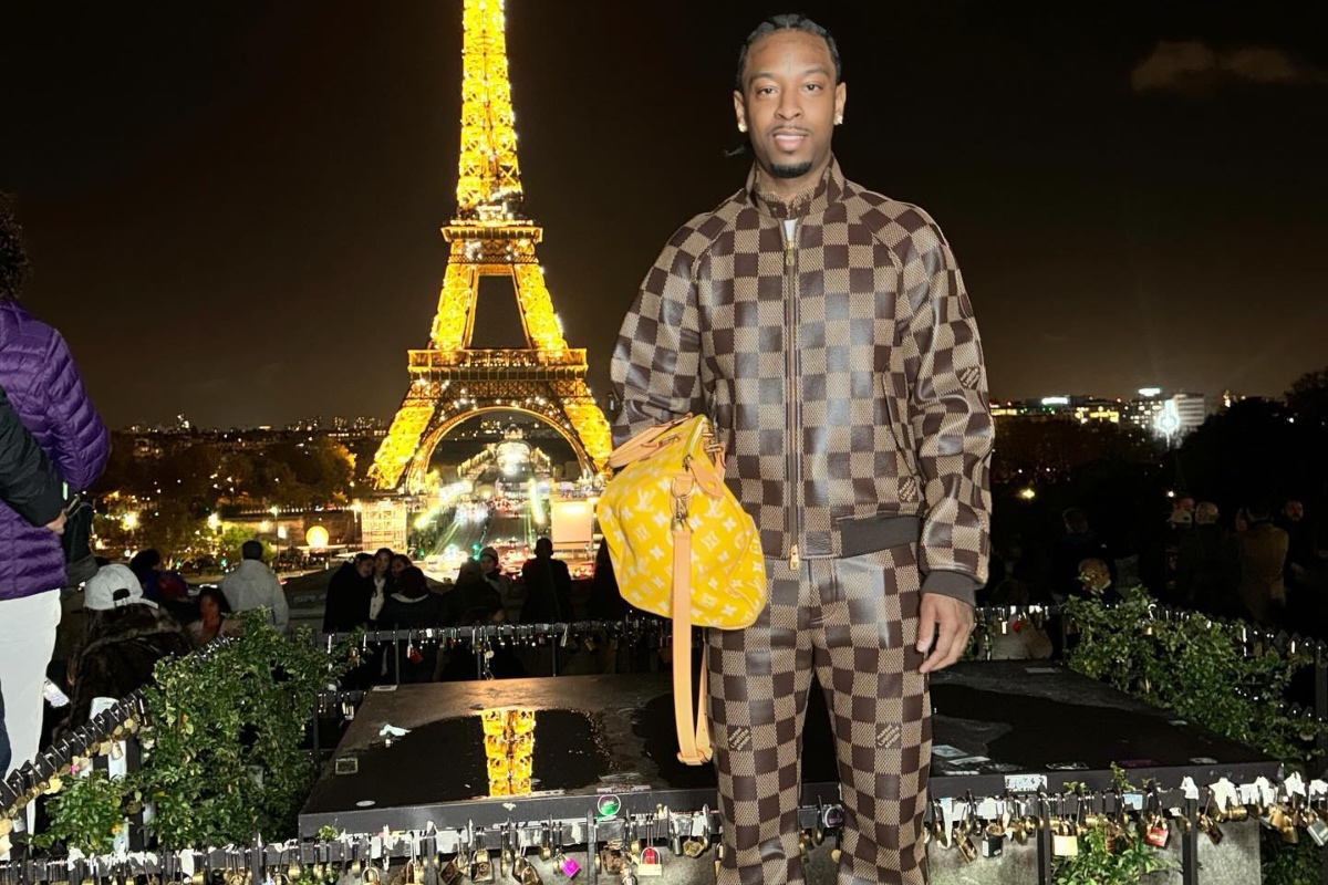 SPOTTED: 21 Savage Hits the Tourist Spots in Paris Wearing Louis Vuitton’s Millionaire Speedy Bag & Supreme x Nike