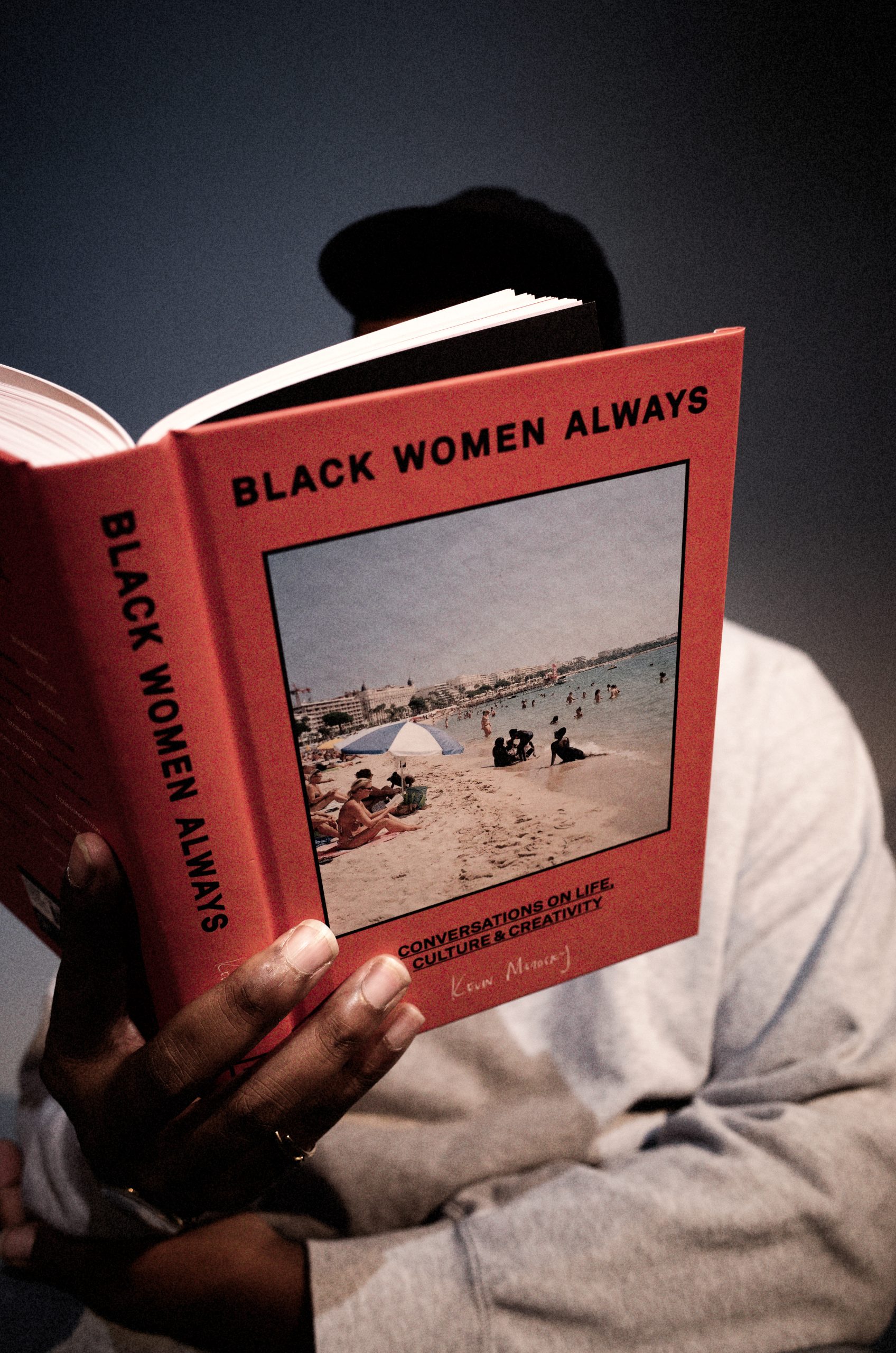 holding book Black Women Always