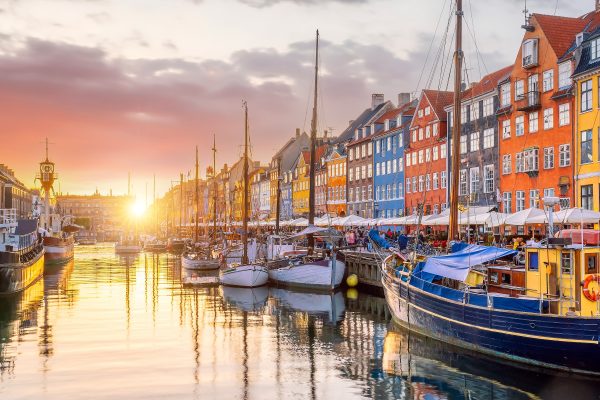 Cityscape of downtown Copenhagen city skyline in Denmark at famous old Nyhavn port at sunset