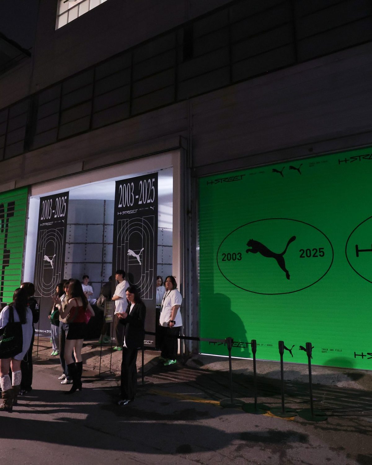 SEOUL, SOUTH KOREA - MAY 15: People have chats in front of the Studio Layer 41 during the PUMA H-Street Launch Experience on May 15, 2025 in Seoul, South Korea. (Photo by Chung Sung-Jun/Getty Images for PUMA)