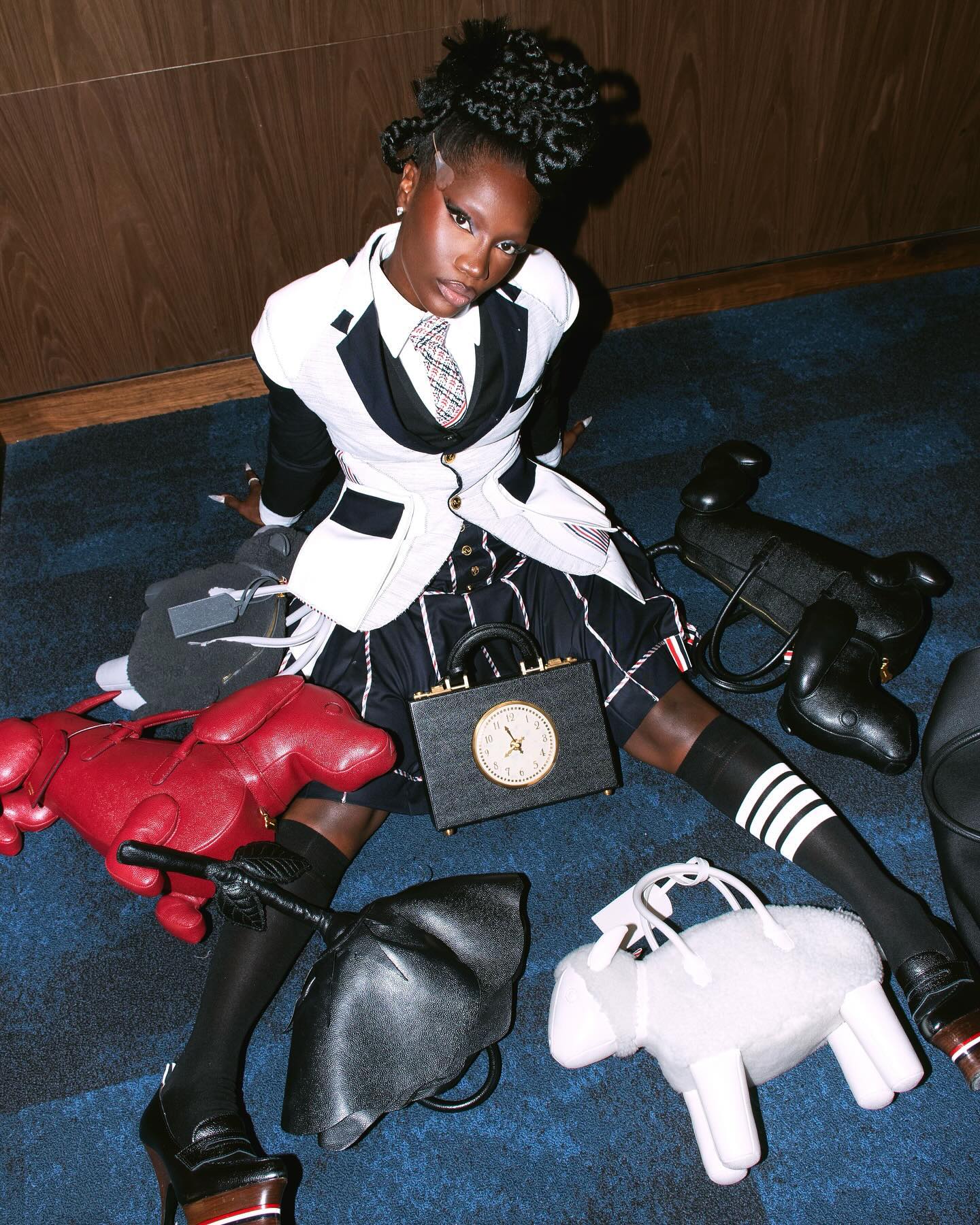 Doechii wears Thom Brown deconstructed blazer, striped skirt, shirt and tweed tie for the 2024 VMAs.